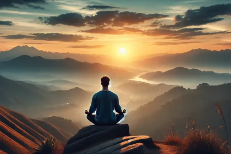 A serene scene of a person sitting in meditation on a hilltop at sunrise